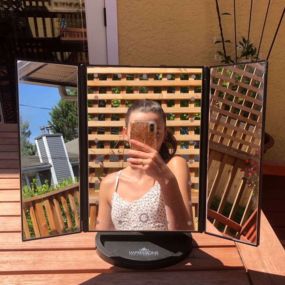 Folding mirror with lights